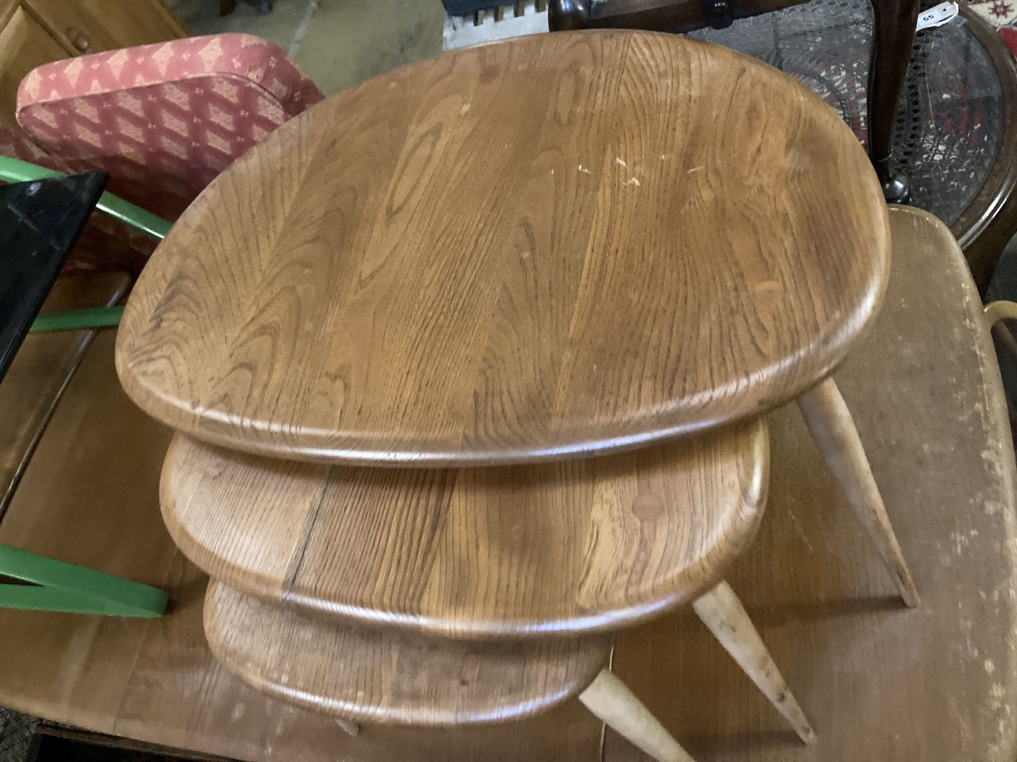 An Ercol nest of three Pebble tables, width 64cm depth 42cm height 40cm